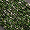 Close-up of green and white faceted beads on a dark background