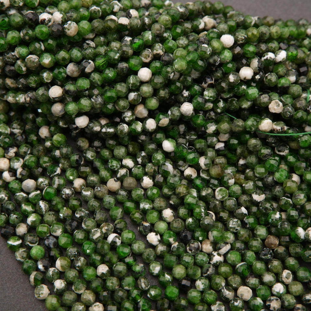 Close-up of green and white bead string on a gray background
