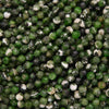Close-up of green and black faceted beads.