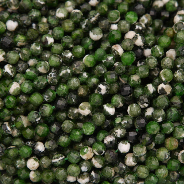 Close-up of green and black faceted beads.