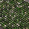 Close-up of green and white faceted beads on a dark background