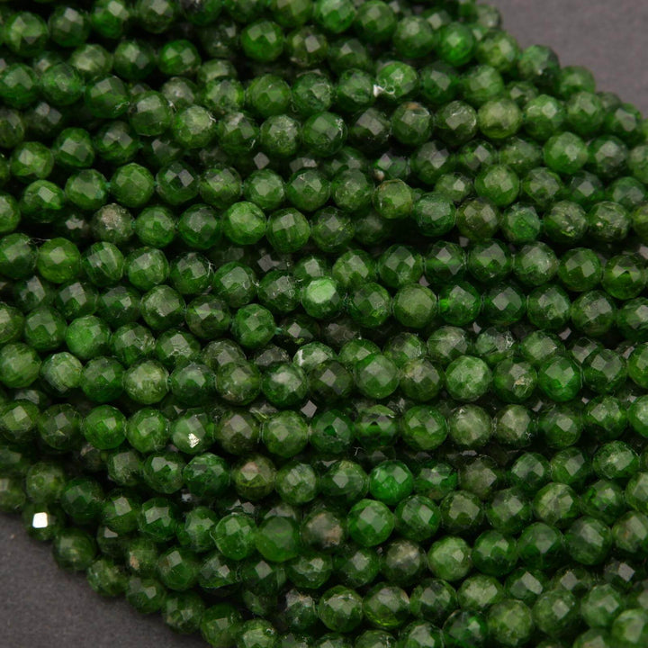Close-up of green faceted beads on a dark background