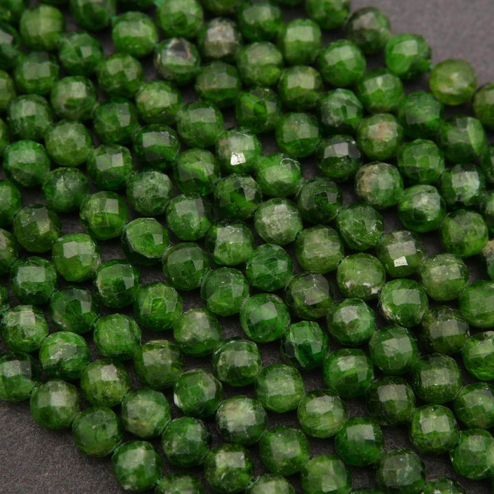 Close-up of green faceted beads on a dark background