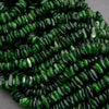 Close-up of green beads with a textured surface on a gray background