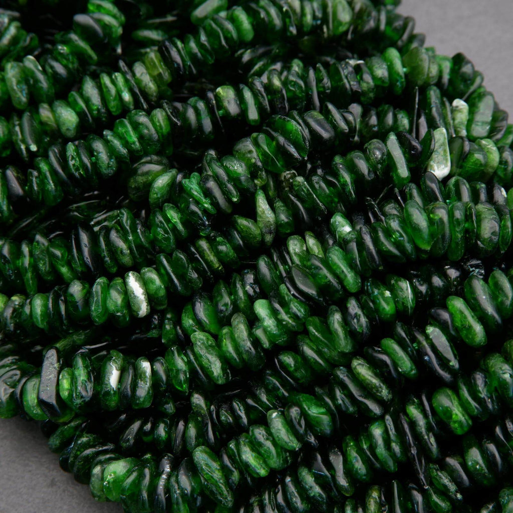 Close-up of green beads with a textured surface on a gray background