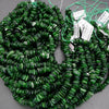 Green beads on a string with tags on a gray background