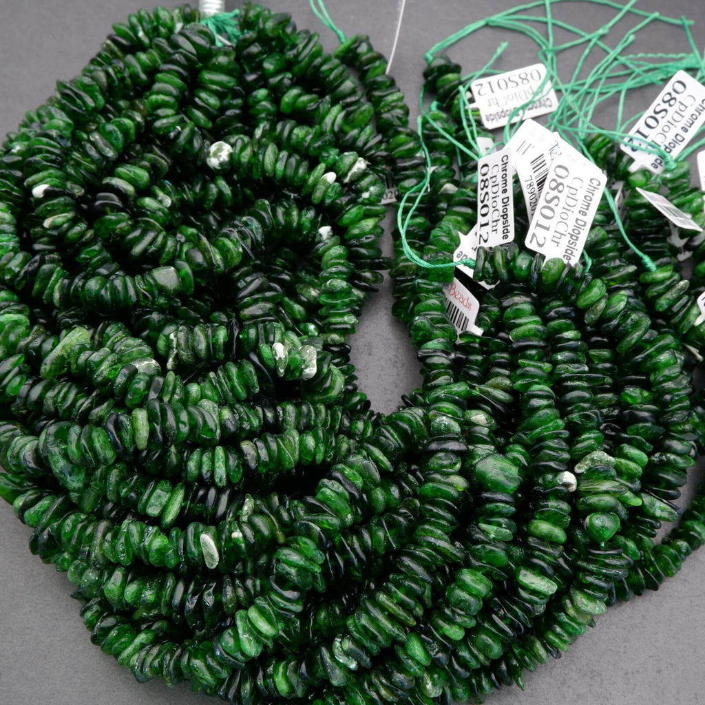 Green beads on a string with tags on a gray background