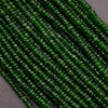Close-up of green glass beads on a dark background