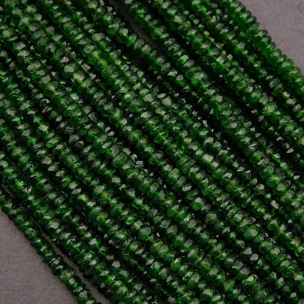Close-up of green glass beads on a dark background