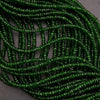 Green beaded necklace on a textured surface