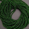 Green beaded necklace on a gray background
