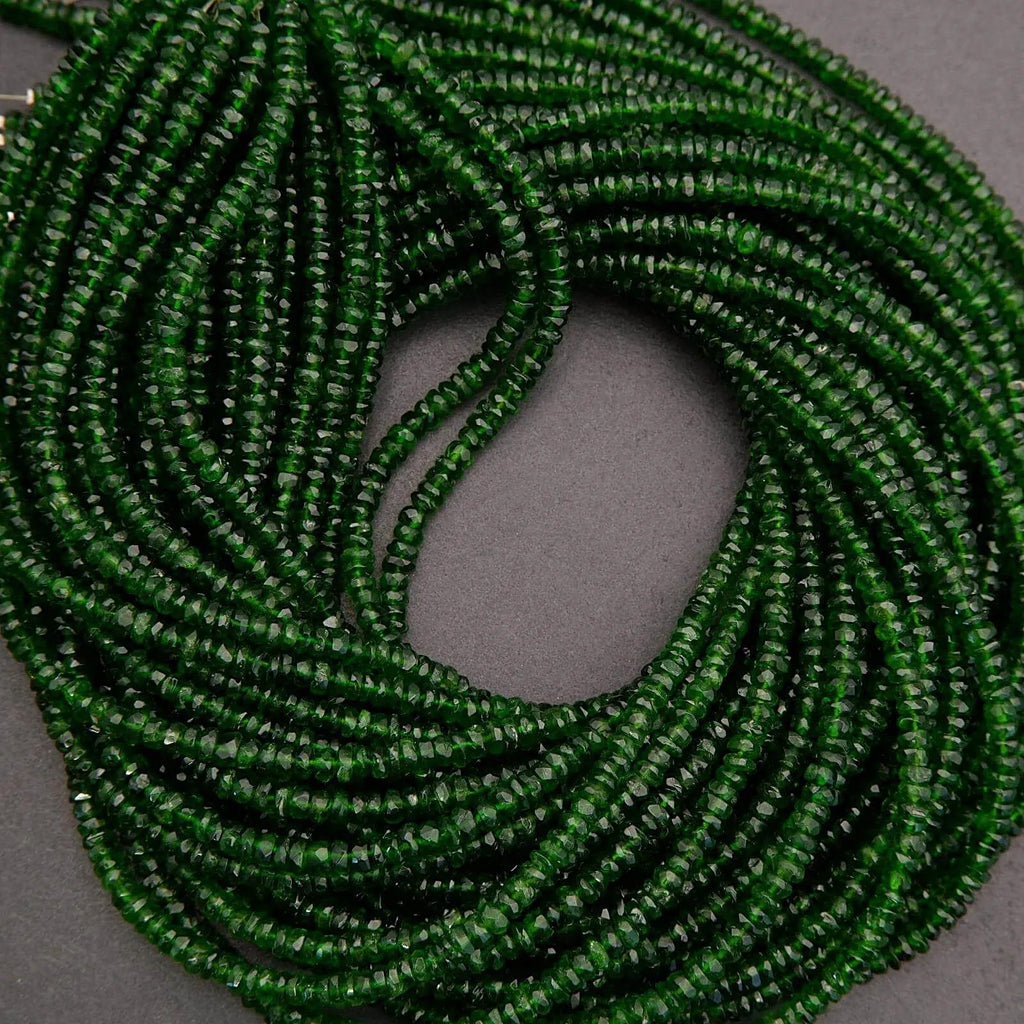 Green beaded necklace on a gray background