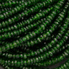 Close-up of green faceted beads on a black background
