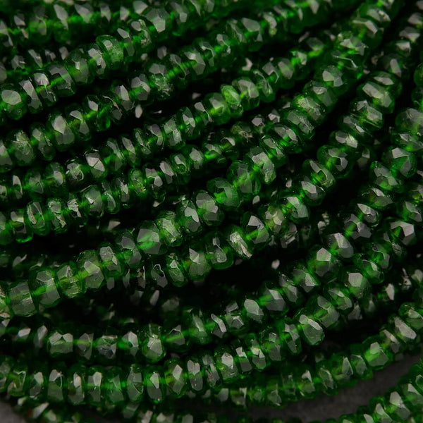 Close-up of green faceted beads on a black background