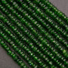 Close-up of green faceted beads on a dark gray background