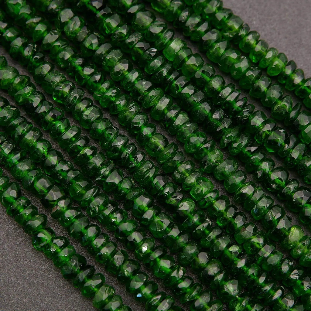 Close-up of green faceted beads on a dark gray background