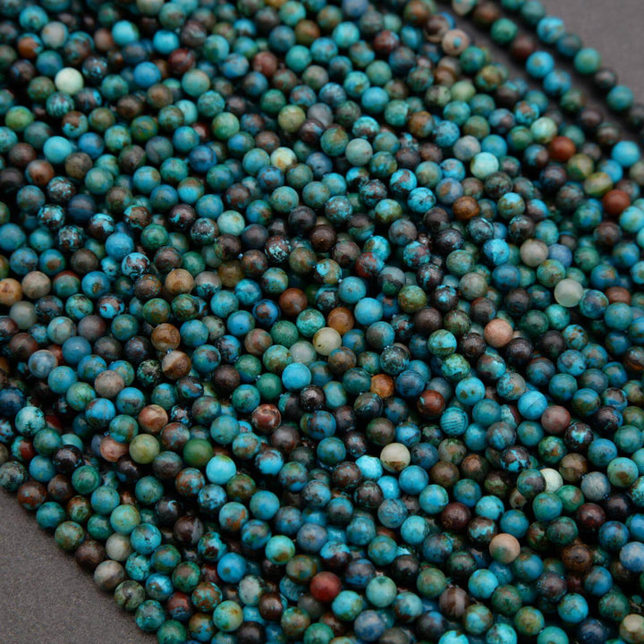 Close-up of blue and green marbled beads on a dark background
