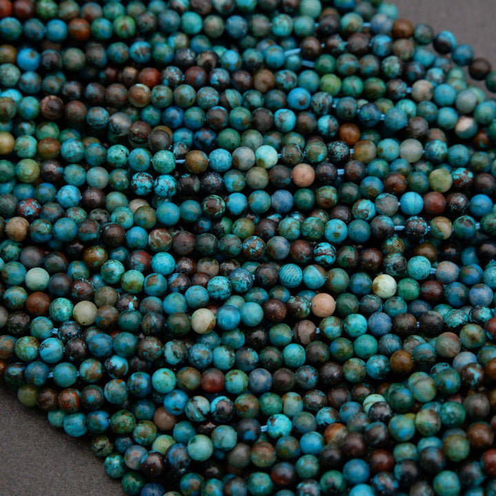 Close-up of blue and green beads on a gray background