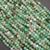 Strands of Chrysoprase beads in mixed green tones, accented by earthy brown and cream patches.