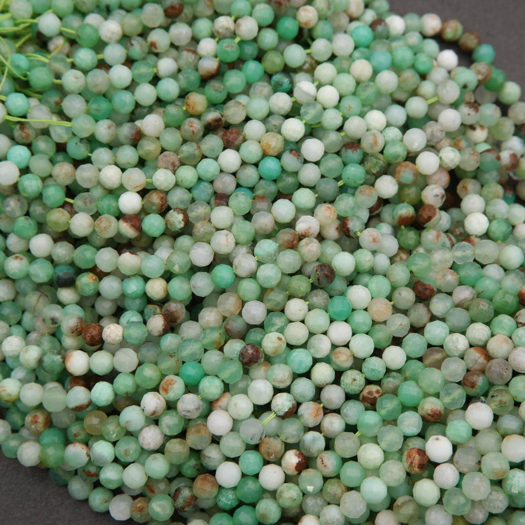 Large bundle of Chrysoprase beads with faceted surfaces, showing a range of mint to deep green hues with natural inclusions.