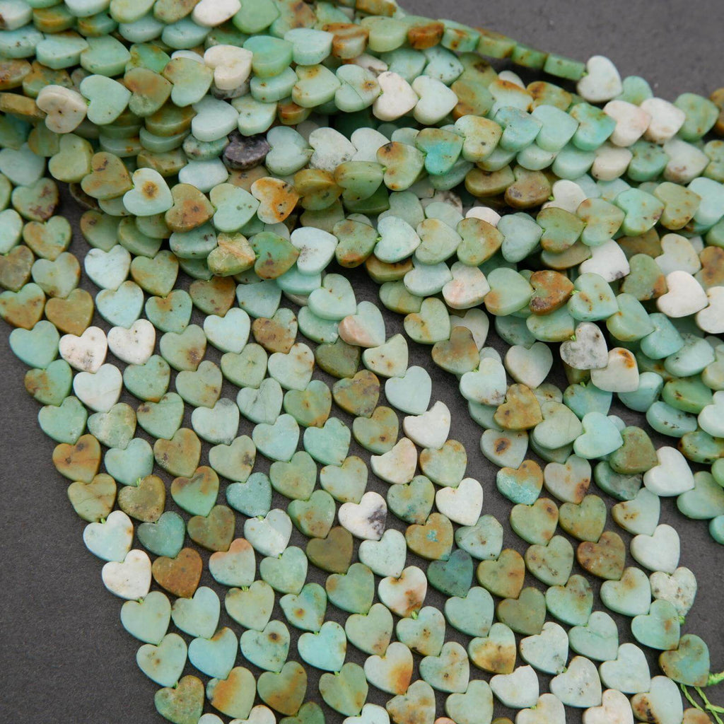 Heart-shaped turquoise stones on a dark surface