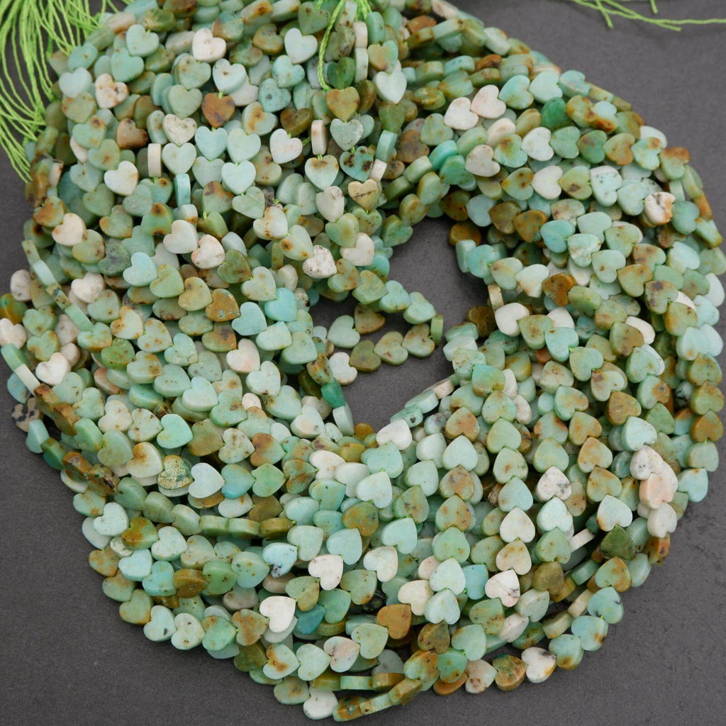 String of green heart-shaped beads on a dark surface