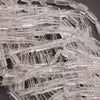Close-up of clear plastic connectors on a dark background