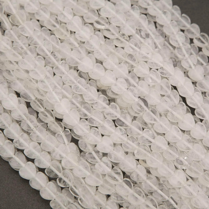 Close-up of clear quartz beads on a gray surface