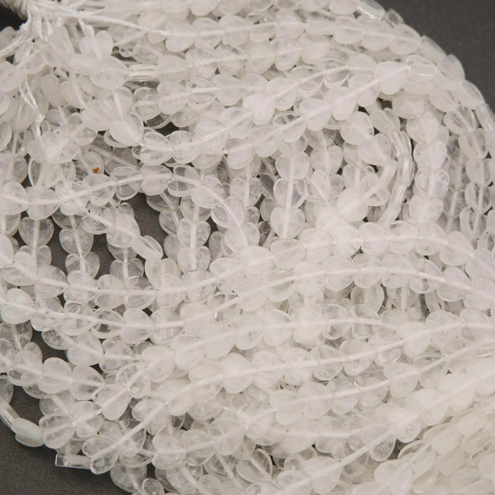 Close-up of clear quartz beads on a gray surface