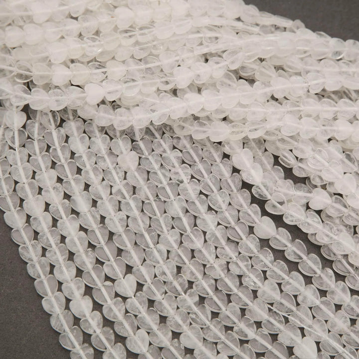 Close-up of clear quartz beads on a gray surface