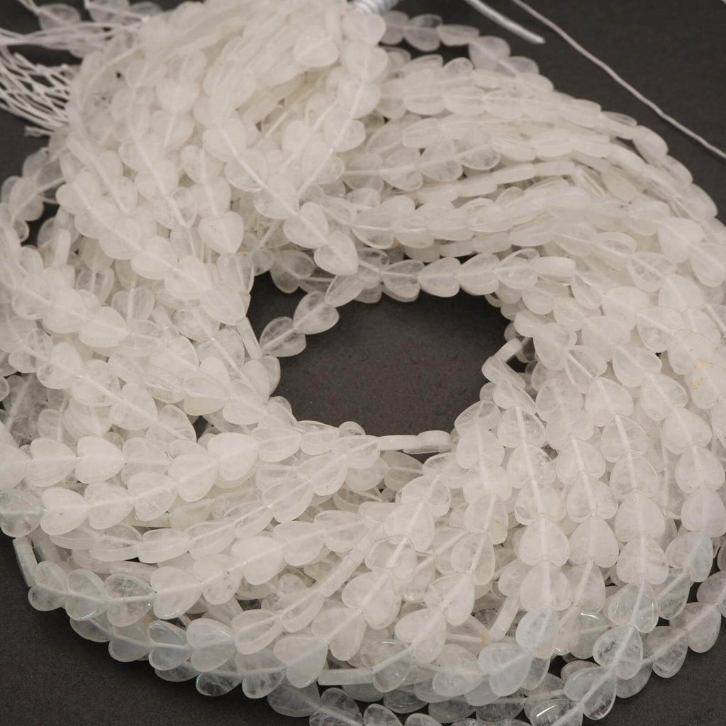 Close-up of a coiled string of clear beads on a dark background
