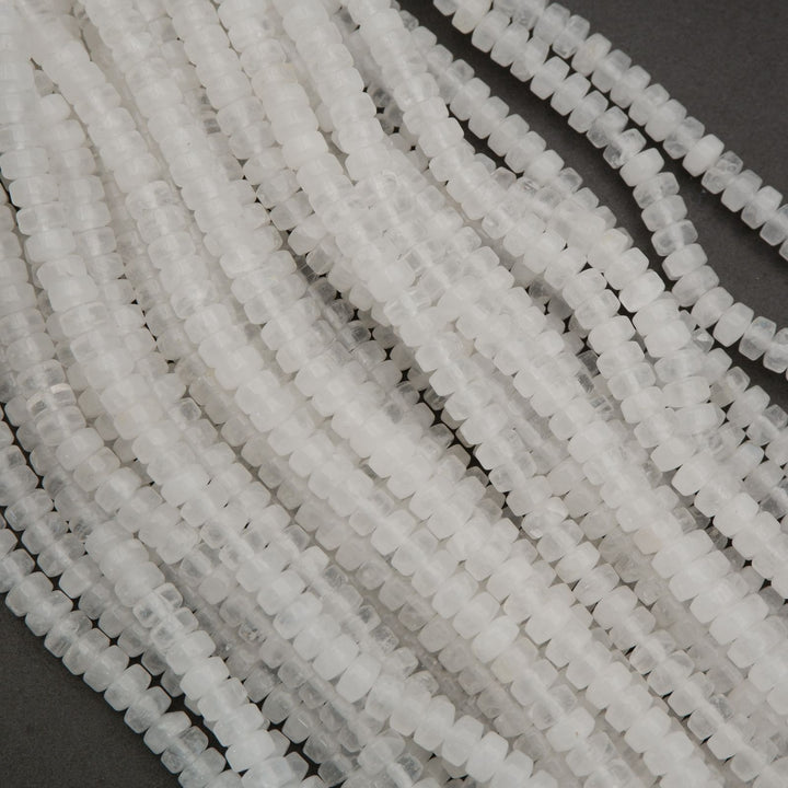 Bundle of clear quartz disc bead strands showing consistent shape and translucent stone quality.
