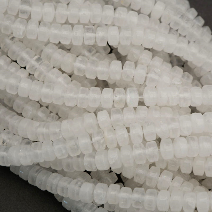 Natural clear quartz heishi beads featuring subtle clarity variation and smooth polished finish.