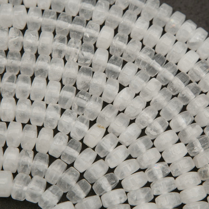 Detailed view of clear quartz heishi bead strands with frosted white and transparent tones.