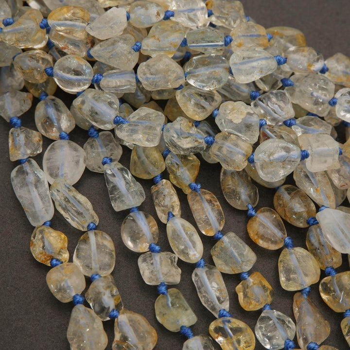 Necklace with clear and yellow teardrop-shaped beads on a dark background