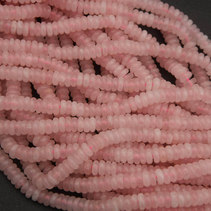Close-up of a string of pink beads on a dark background