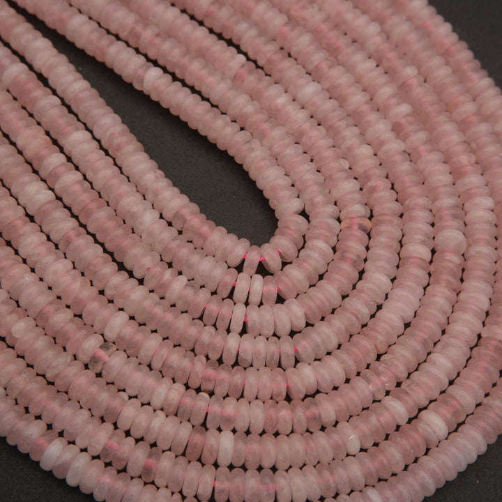 Close-up of a string of pink beads on a dark background