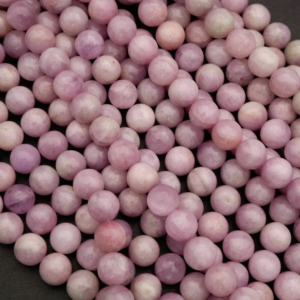 Close-up of pink and purple marbled beads on a black background