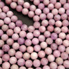 Close-up of pink beads on a dark background