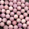 Close-up of pink beads on a dark background