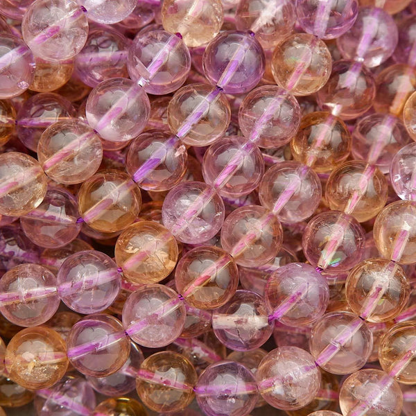 Close-up of multicolored beads with pink strings, likely used as decorative elements.