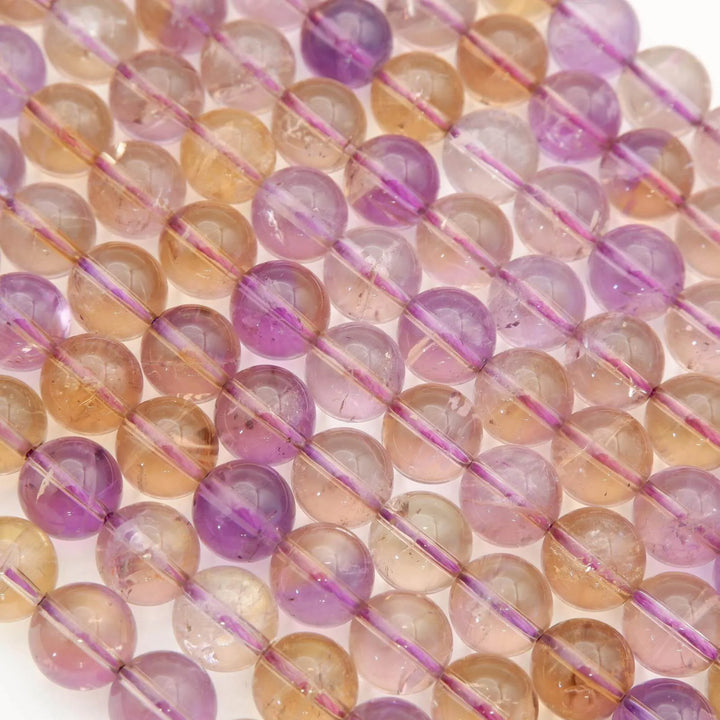 Close-up of multicolored beads on a string with a white background