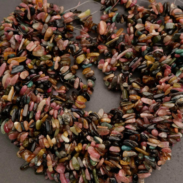 Decorative wreath made of multicolored stones on a gray background
