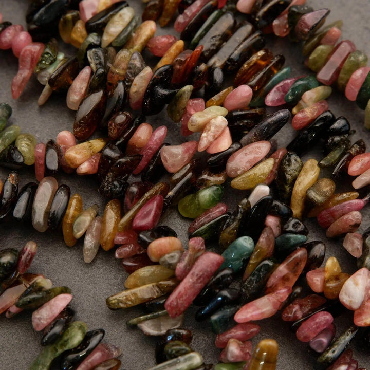 Colorful beads scattered on a gray surface