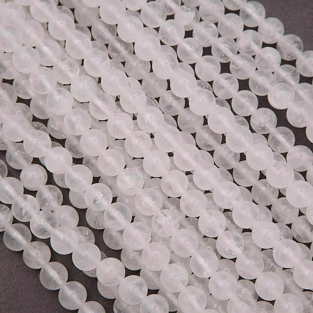 Close up of white milky quartz round gemstone beads on strand