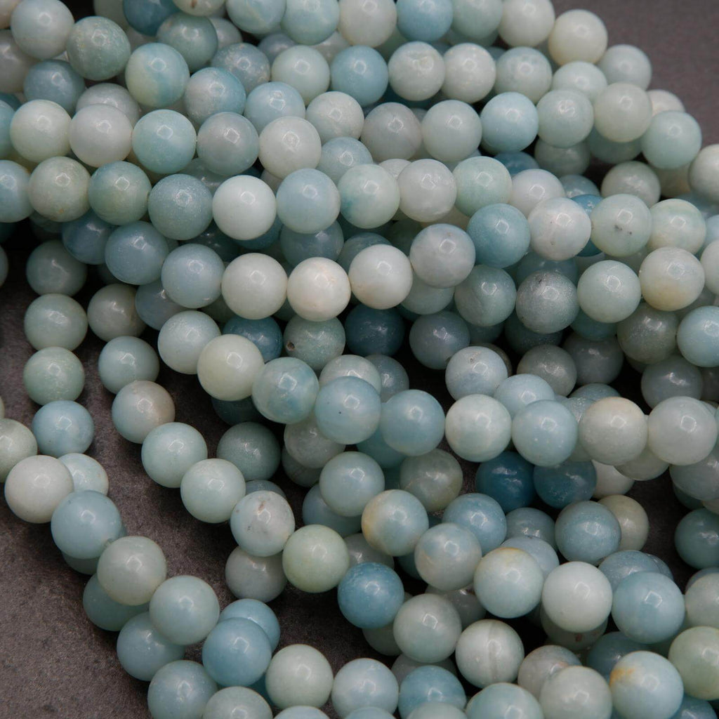 Close-up of light blue and white beads on a dark background