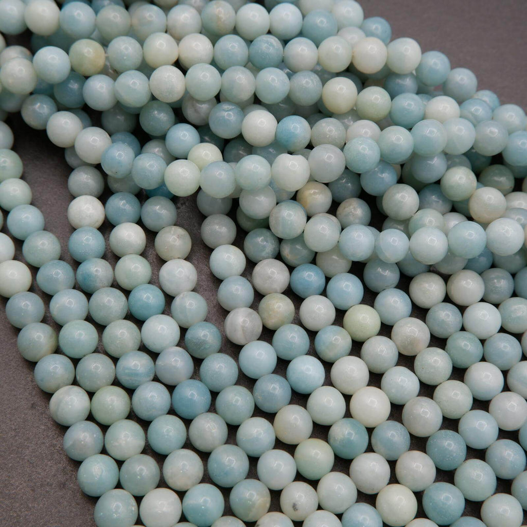 Close-up of light blue and white beads on a dark background