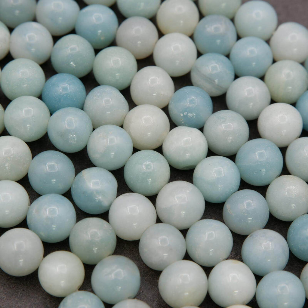 Close-up of light blue and white beads on a gray background