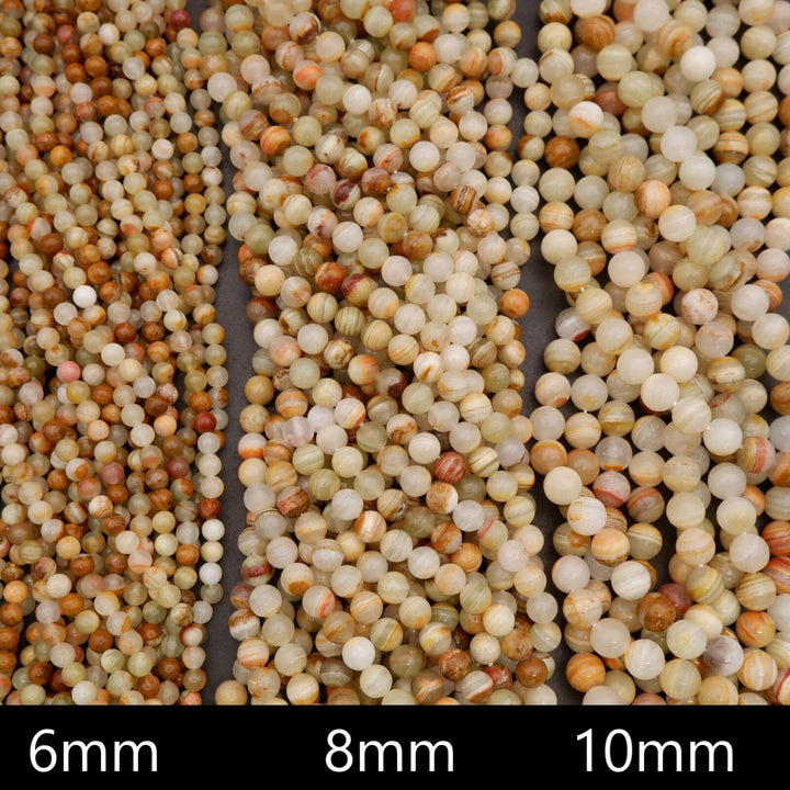 Close-up of quinoa grains with size labels 6mm, 8mm, and 10mm.