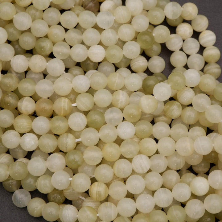 Close-up of light-colored beads on a dark background